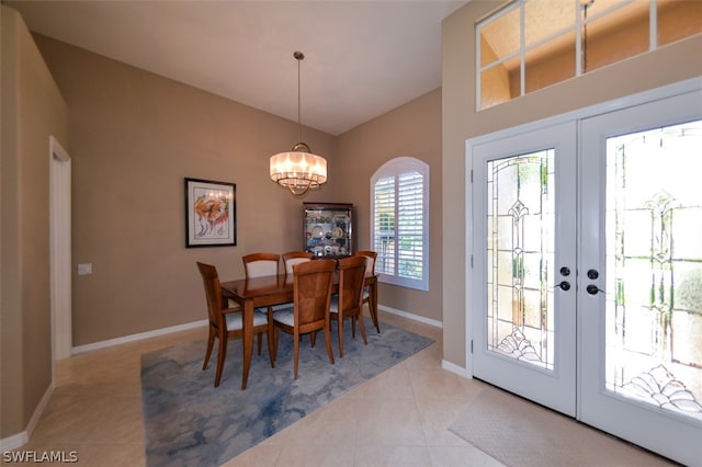 tiled dining area with french doors, lofted ceiling, and a notable chandelier