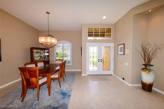 dining room with a notable chandelier, french doors, and light tile patterned flooring