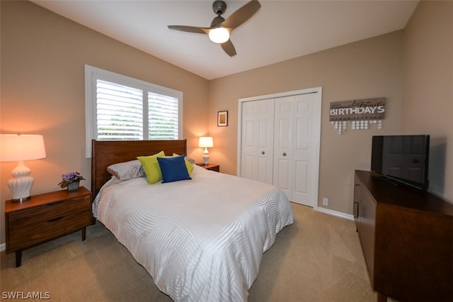 carpeted bedroom with ceiling fan and a closet