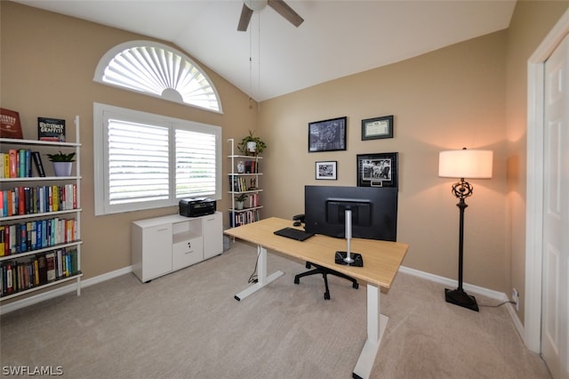 carpeted home office with ceiling fan and vaulted ceiling