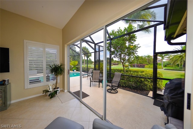 interior space with light tile patterned flooring and vaulted ceiling