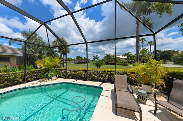 view of swimming pool featuring a patio area and glass enclosure