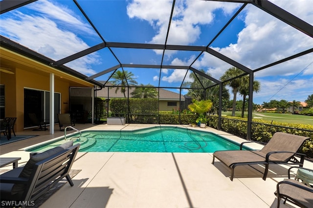 view of swimming pool featuring a patio area and glass enclosure