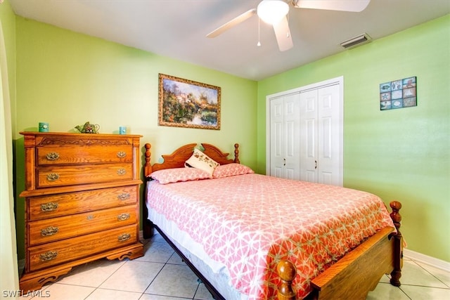 bedroom with a closet, ceiling fan, and light tile floors