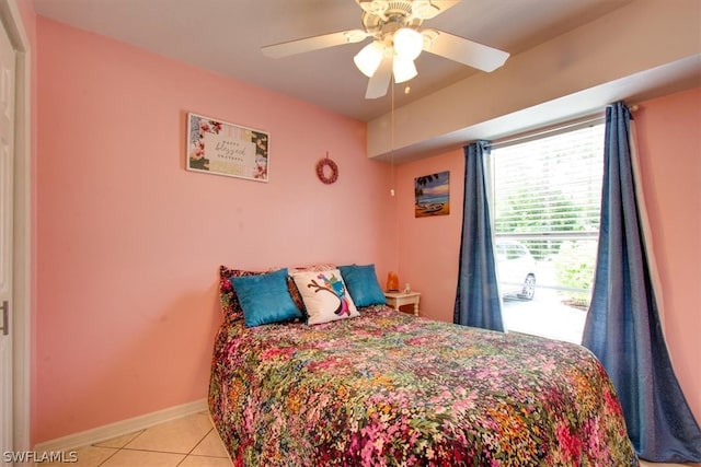 tiled bedroom featuring ceiling fan