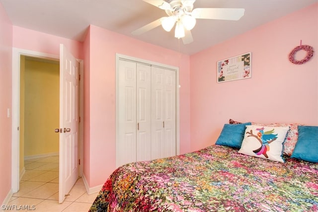 bedroom with a closet, ceiling fan, and light tile flooring