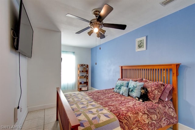 tiled bedroom featuring ceiling fan