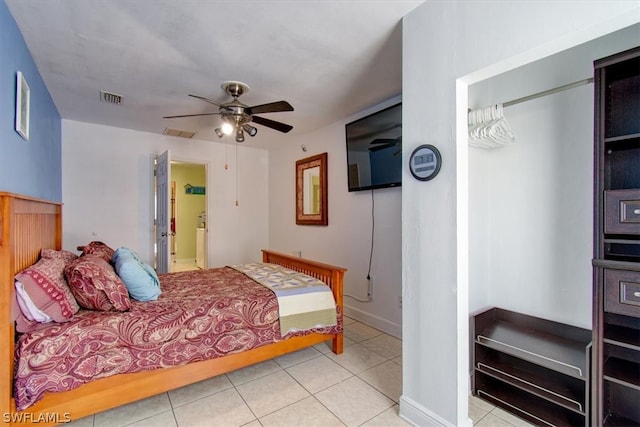 tiled bedroom featuring ceiling fan