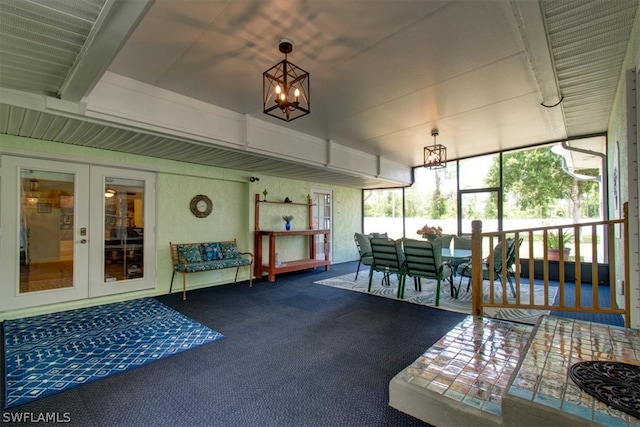 sunroom / solarium featuring french doors and a chandelier