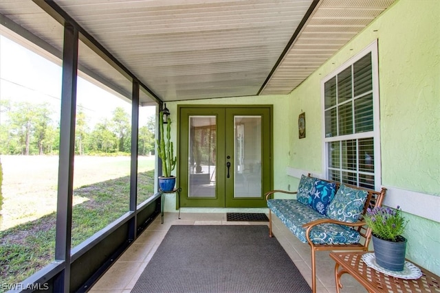 unfurnished sunroom with vaulted ceiling, french doors, and a healthy amount of sunlight