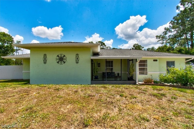 view of front of property with a front yard and a patio area