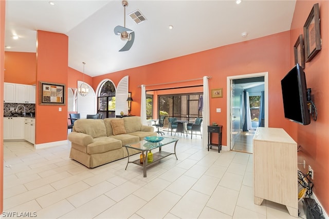 tiled living room featuring high vaulted ceiling and sink