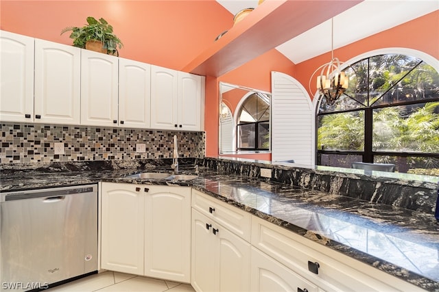 kitchen featuring white cabinets, dark stone counters, light tile floors, and stainless steel dishwasher