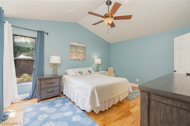 bedroom featuring light hardwood / wood-style flooring, ceiling fan, and multiple windows