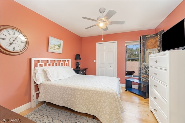 bedroom featuring a closet, light hardwood / wood-style flooring, ceiling fan, and access to exterior