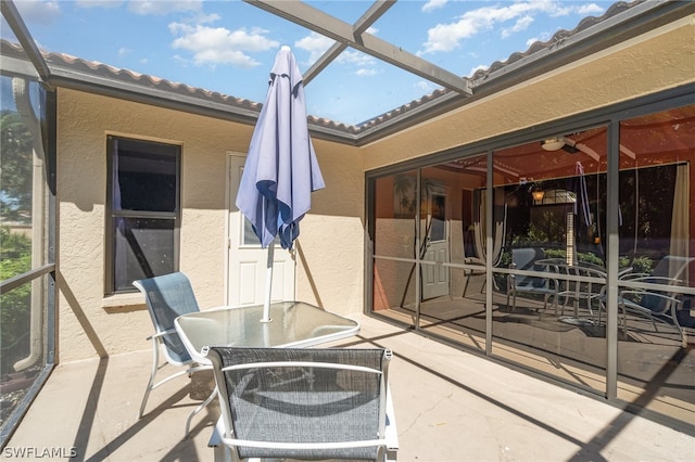 view of patio with glass enclosure