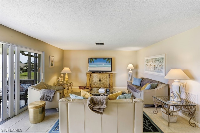 tiled living room with a textured ceiling