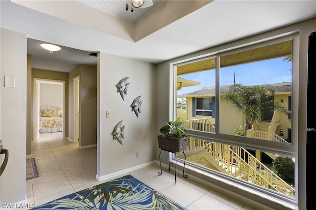 entryway with light tile patterned floors and a healthy amount of sunlight