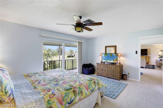 tiled bedroom with ceiling fan, a textured ceiling, and access to exterior