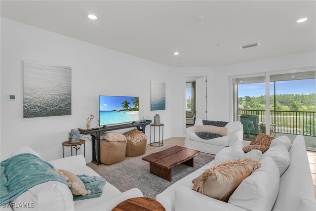 living area featuring recessed lighting and visible vents