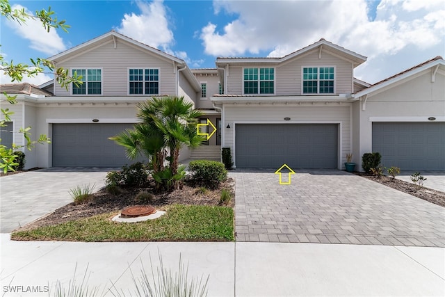 view of front of property featuring a garage and decorative driveway
