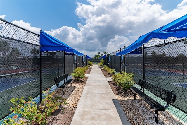 surrounding community featuring fence and a tennis court