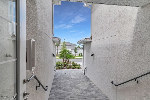 view of side of home featuring a patio area and stucco siding