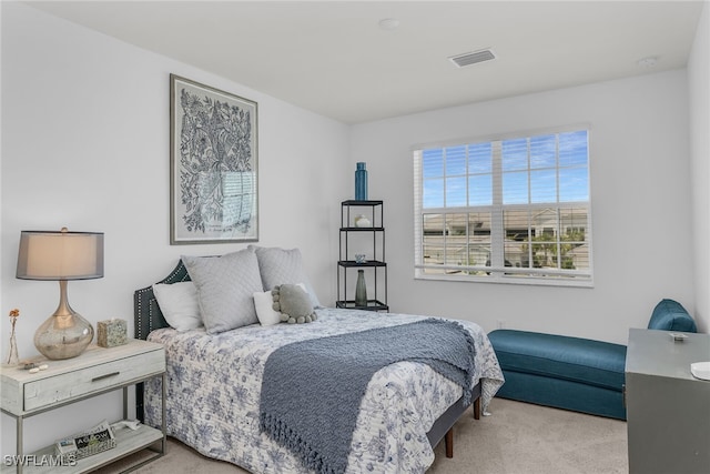 carpeted bedroom featuring visible vents
