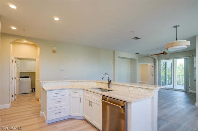 kitchen with light hardwood / wood-style flooring, washer / clothes dryer, dishwasher, and decorative light fixtures