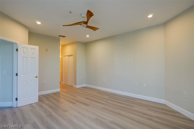 empty room with light hardwood / wood-style flooring and ceiling fan