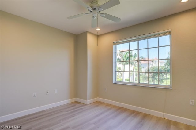 unfurnished room with ceiling fan and light wood-type flooring