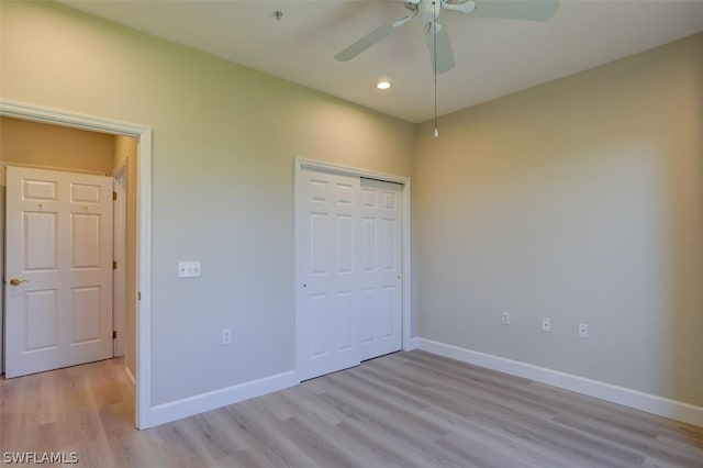 unfurnished bedroom featuring a closet, hardwood / wood-style floors, and ceiling fan