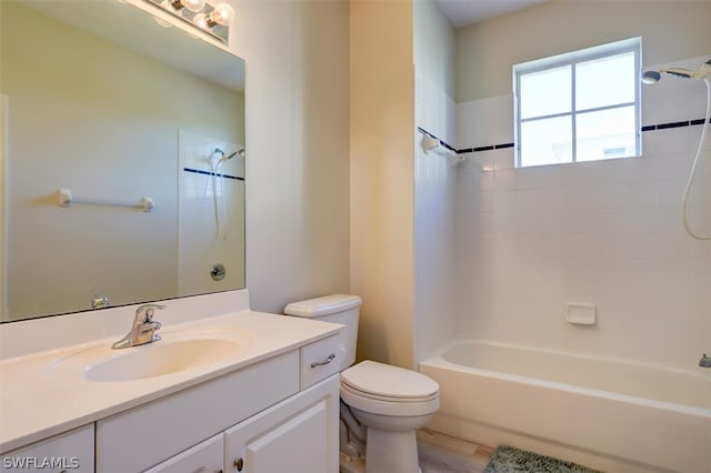 full bathroom featuring vanity, tiled shower / bath combo, toilet, and hardwood / wood-style flooring