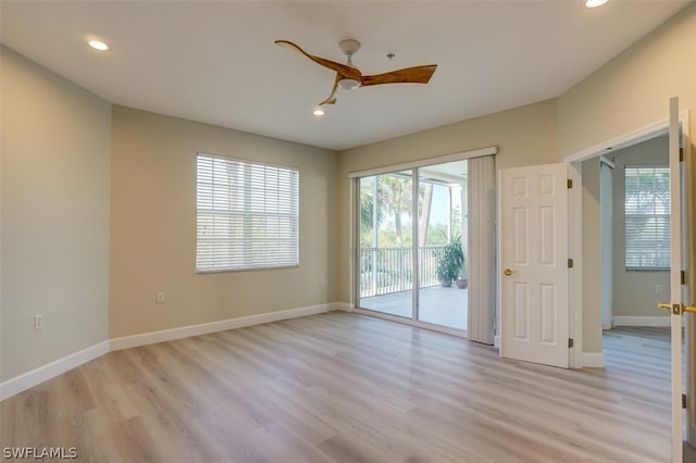 spare room featuring ceiling fan and light wood-type flooring