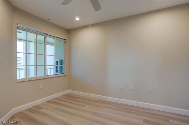 empty room with plenty of natural light, ceiling fan, and light hardwood / wood-style floors