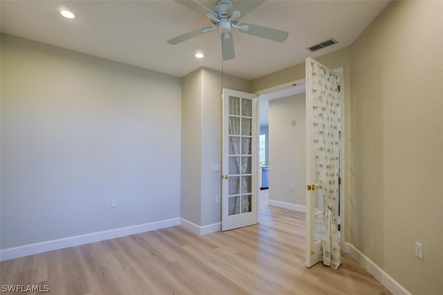 empty room with light hardwood / wood-style flooring and ceiling fan