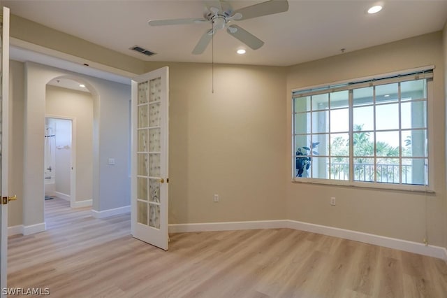 spare room with ceiling fan and light wood-type flooring