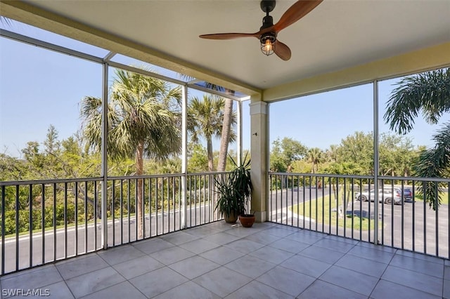 unfurnished sunroom featuring ceiling fan