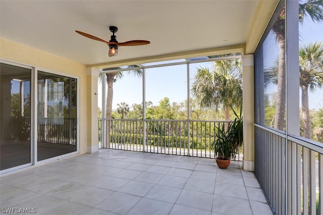 unfurnished sunroom with ceiling fan