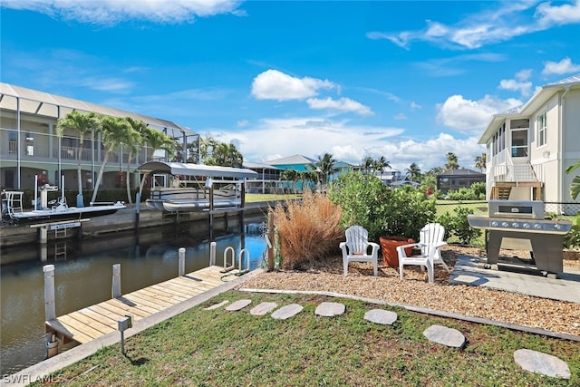 view of dock with a lawn, a water view, and glass enclosure