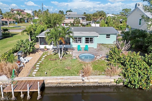 rear view of property with a patio, a water view, and a lawn