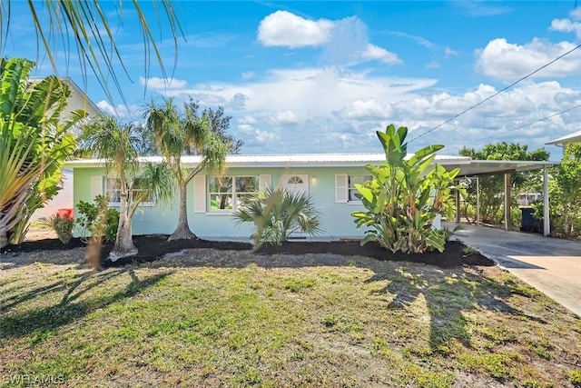 single story home featuring a front lawn and a carport