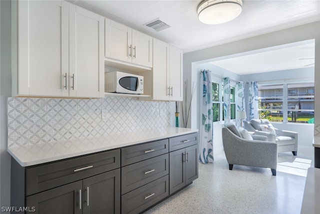 kitchen featuring white cabinetry and tasteful backsplash