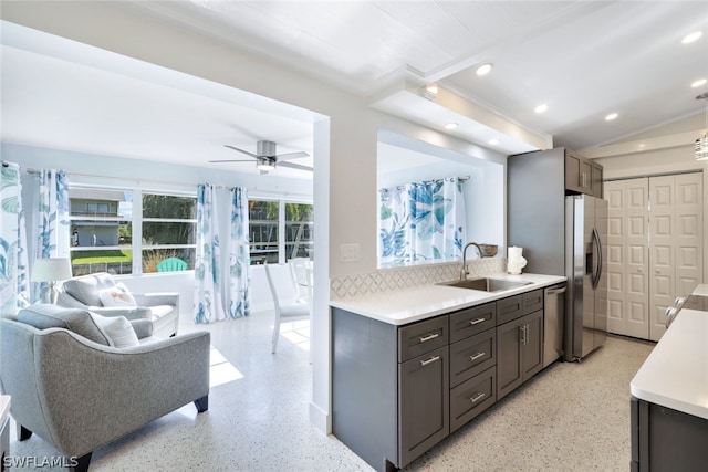 kitchen with sink, appliances with stainless steel finishes, dark brown cabinets, and ceiling fan