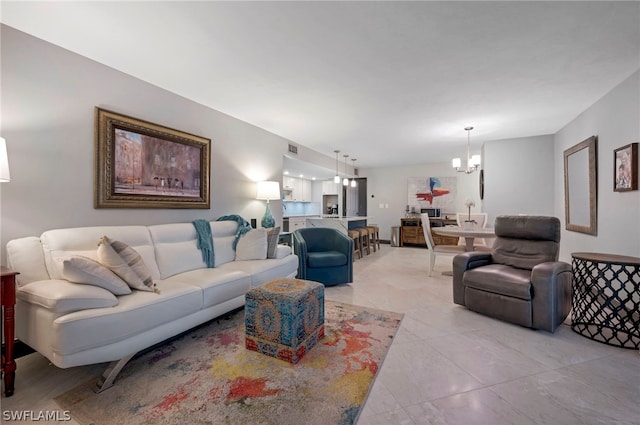 living room with a notable chandelier and tile floors