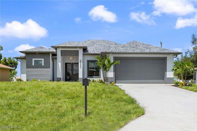 view of front of property featuring a garage and a front yard