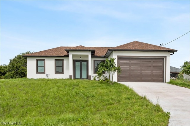 view of front of house featuring a front yard and a garage