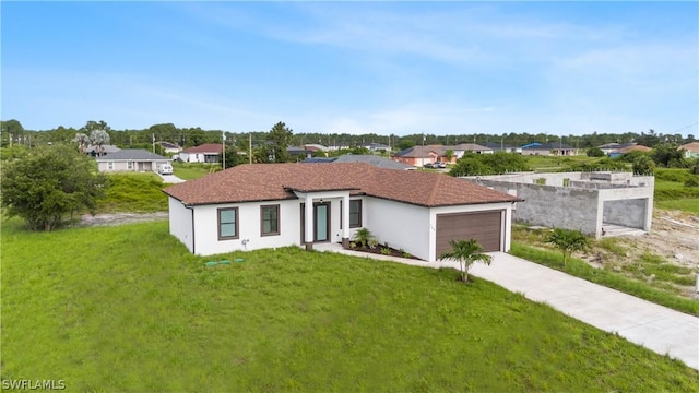 view of front of home featuring a front lawn and a garage