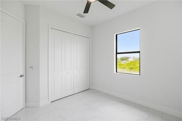 unfurnished bedroom with a closet and ceiling fan