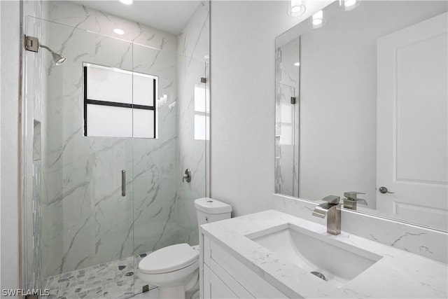 bathroom with vanity, an enclosed shower, and toilet